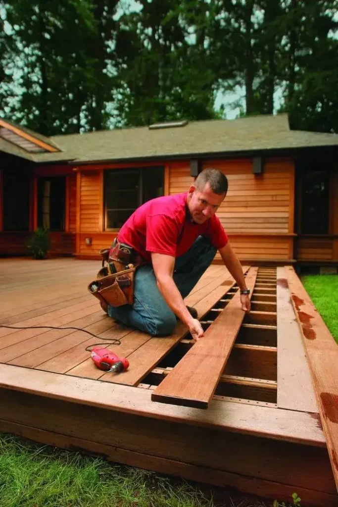 Craftsman installing timber boards, expertly done by Deck builders Alexandra at Builders Alexandra.